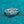 Silver ring with a diamond on a teal background
