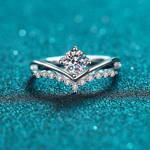 Silver ring with a diamond on a teal background