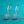 Silver floral earrings on a teal fabric background