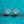 Pair of diamond earrings on a teal background