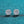 Pair of diamond earrings on a teal glittery background