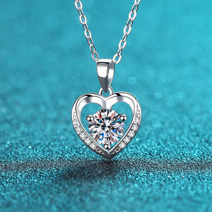 Silver heart-shaped necklace with a diamond on a blue background