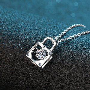 Silver necklace with a diamond pendant on a textured black and blue background