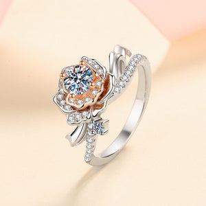 Rose gold and silver ring with diamond accents on a beige background