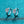 Pair of silver hoop earrings with gemstones on a blue textured background