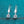 Silver earrings with clear gemstones on a blue glittery background