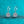 Silver earrings with star-shaped gemstones on a turquoise glitter background