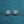 Pair of diamond earrings on a blue glittery background