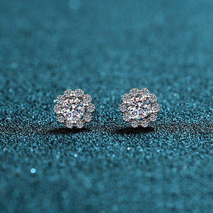 Pair of diamond earrings on a blue glittery background