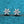 Silver snowflake earrings on a blue textured background