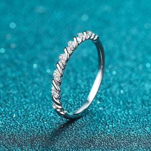 Silver ring with diamonds on a blue textured background