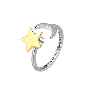 Silver spinner ring with a gold star and engraved text on a light gray background
