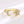 Gold spinner ring with star and moon design on a white background