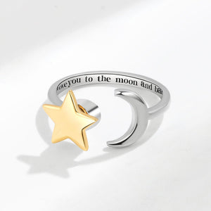 Silver spinner ring with a gold star and engraved text on a light gray background