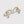 Gold earrings with star and moon designs on a light gray background