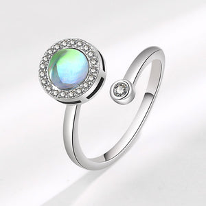 Silver ring with a green gemstone on a white background