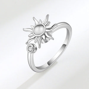 A silver band ring with a sun motif and a small cubic zirconia stone, displayed against a white background.