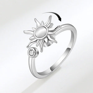 A silver band ring with a sun motif and a small cubic zirconia stone, displayed against a white background.