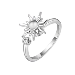 A silver band ring with a sun motif and a small cubic zirconia stone, displayed against a white background.