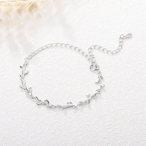 Silver bracelet on a textured white surface