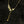 Gold necklace with leaf design on a black background