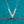 Silver 'V' necklace with diamonds on a teal background