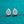Teardrop-shaped diamond earrings on a teal background
