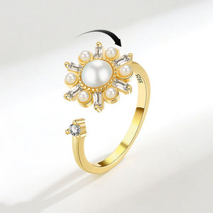 Gold ring with pearls and diamonds on a white background