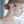 Close-up of a woman wearing elegant floral earrings with a blurred background