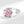 Silver ring with pink flower-shaped gemstones on a white background