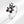 Silver ring with black bear-shaped design and pink gem on a white background