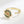 Gold spinner ring with saturn charm on a white background
