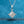 Diamond pendant necklace on a blue textured background