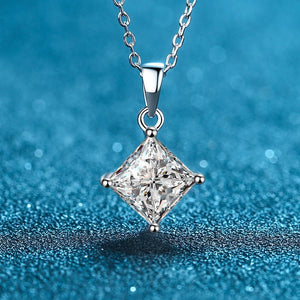 Diamond pendant necklace on a blue textured background