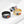 Four rings in black, silver, gold, and rainbow colors on a white background