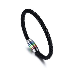 A series of leather bracelets with gold plating and rainbow-colored accents on a white background, representing the LGBTQ pride colors.