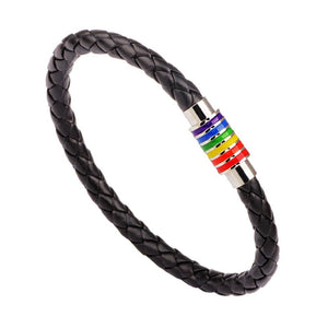 A series of leather bracelets with gold plating and rainbow-colored accents on a white background, representing the LGBTQ pride colors.