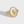 Gold ring with a tulip design on a white background