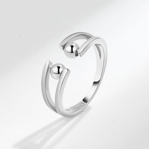 A silver-colored round beads fidget spinner ring with gold plating, displayed against a white background.