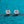 Pair of diamond stud earrings on a textured blue background