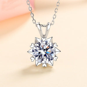 Silver necklace with a diamond pendant on a beige background