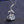 Silver swan-shaped necklace with a clear gemstone on a dark textured background