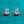 Pair of diamond stud earrings on a teal background