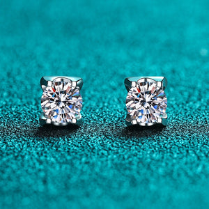 Pair of diamond stud earrings on a teal background