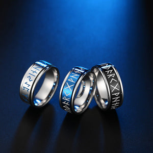 Three metallic rings with engraved text on a blue background