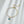 A gold-plated, sterling silver half chain bracelet with a seashell-shaped pendant and pearl beads.