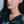 A model wearing small hoop earrings with gold plating, displayed against a white background.