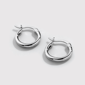 A set of two small hoop earrings with white gold plating, displayed against a white background.