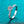 Silver ring with a large diamond and smaller stones on a teal background