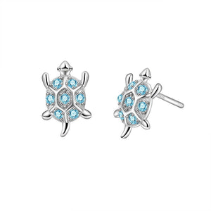A pair of small blue sea turtle stud earrings made of sterling silver with hypoallergenic finish.